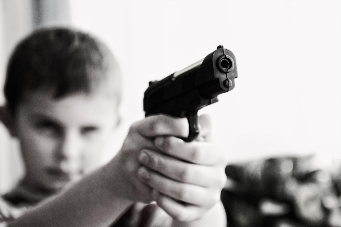 little-boy-holding-gun-safety-training