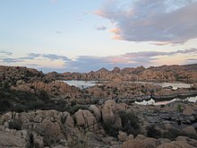 Granite Dells – A Photographer’s Dream-Rock formations at Granite Dells, Prescott, Arizona-Sunset over the dramatic Granite Dells landscape-Scenic view of Granite Dells and Watson Lake-Breathtaking landscape of Granite Dells at sunrise-Rugged rock formations and clear skies at Granite Dells-Hiking path through the unique boulders of Granite Dells-Panoramic view of Granite Dells with lake and desert scenery